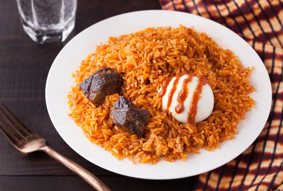 Jollof Peacock rice with beef, boiled egg and shito sauce